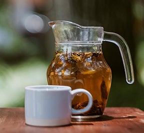 Peach tea sitting on an outdoor table.
