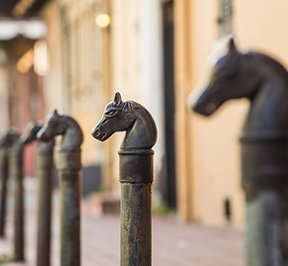 Horse head posts lining a street in the French Quarter. 