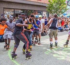 People roller skating downtown.