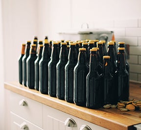 Unlabeled beer sitting on a counter.