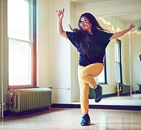 Young woman dancing in a studio. 