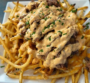 French fries covered in meat and cheese.