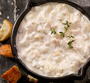 Clam chowder in a cast iron skillet.