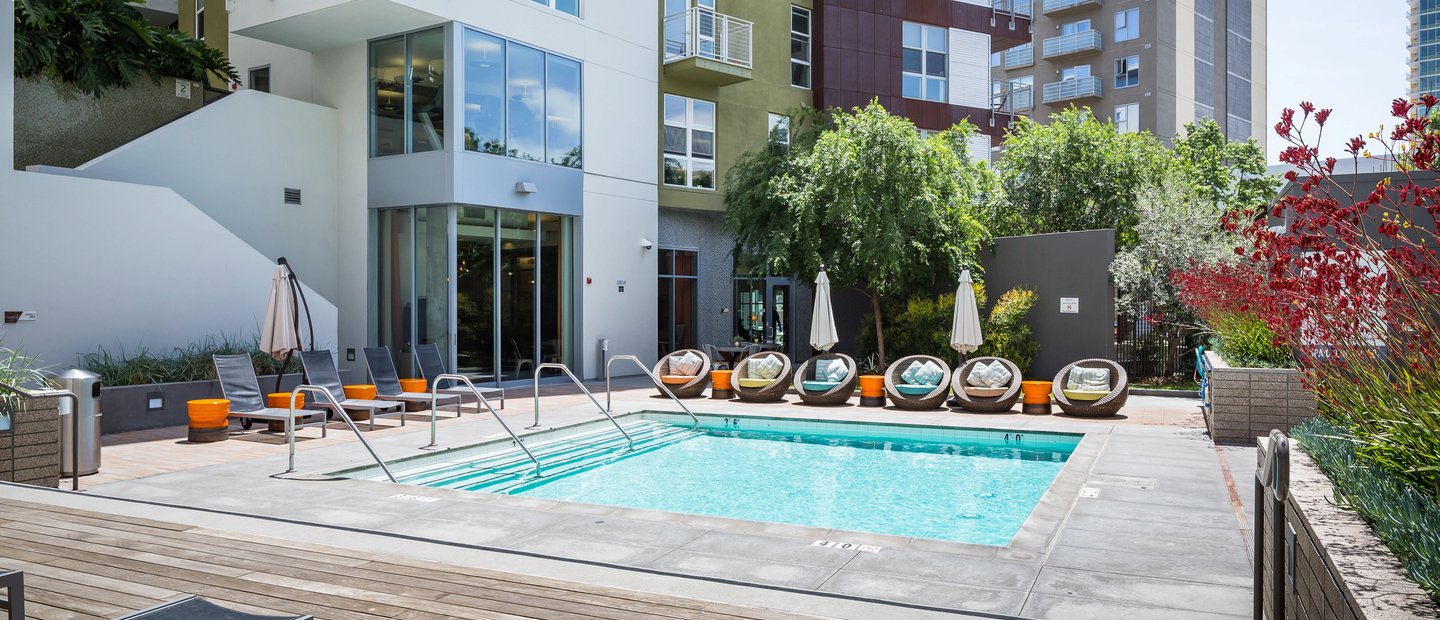 Turquoise water pool surrounded lounge chairs.