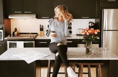 Blogger @champagneandmacaroons enjoying her morning coffee at Stay Alfred at 4Marq in Minneapolis